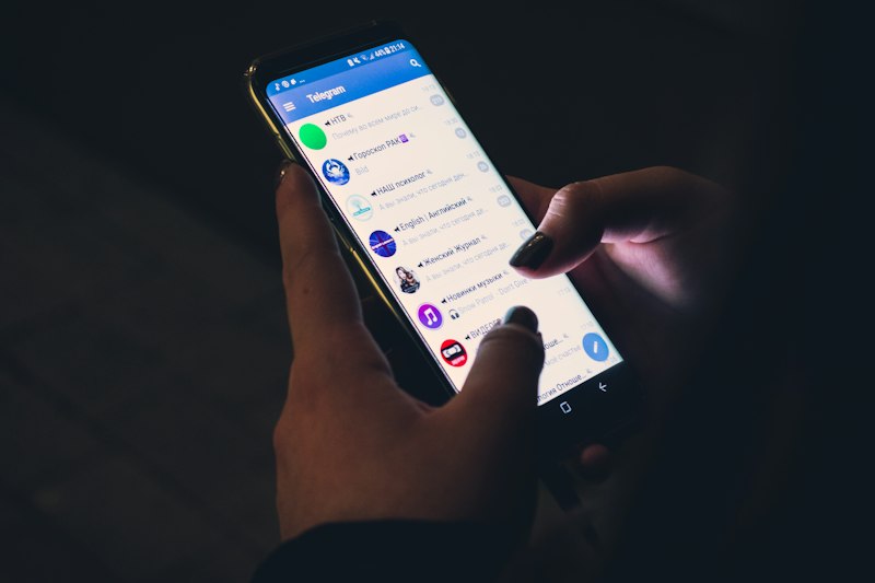 Person looking cautiously at mobile message